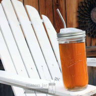 Pint and a half jar with stainless steel straw on an Adirondack chair
