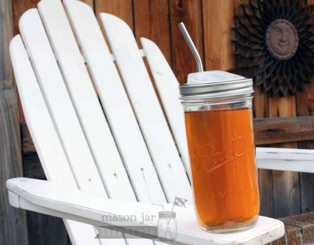Pint and a half jar with stainless steel straw on an Adirondack chair