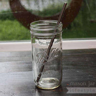 Stainless steel straw with rounded ends in pint & half Ball Mason jar