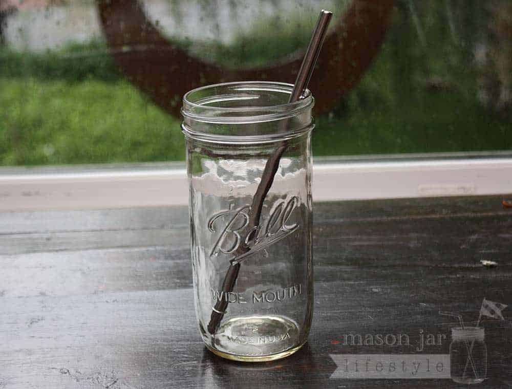 Stainless steel straw with rounded ends in pint & half Ball Mason jar