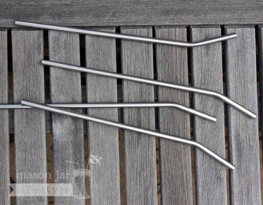 4 9.5" Stainless steel straws on a wood table