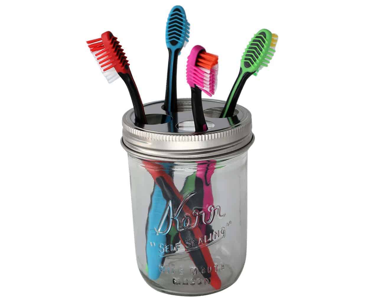Toothbrush holder lid on wide mouth Kerr pint jar with toothbrushes