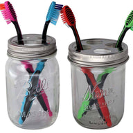 Toothbrush holder lids on wide mouth Kerr pint jar and regular mouth Ball pint jar with toothbrushes