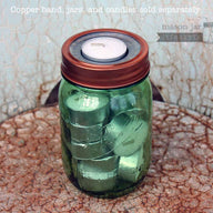 Metal tea light candle holder insert with copper band on green Ball jar with extra tea lights