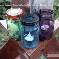 Three types of tea light candle holders on green, blue, and purple Ball Mason jars