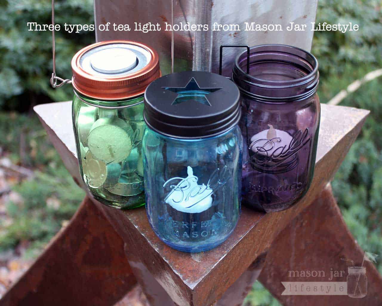 Three types of tea light candle holders on green, blue, and purple Ball Mason jars