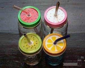 Fruit tumbler lids with straws in regular mouth Mason jars - watermelon, dragon fruit, kiwi, and lemon