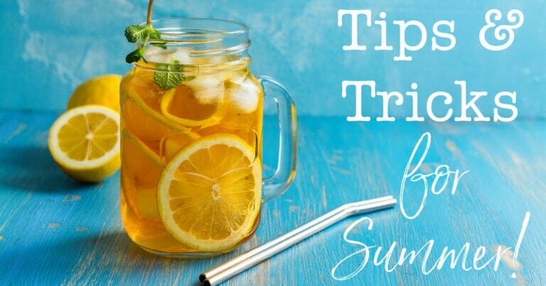 A Mason jar filled with lemon iced tea with a mint garnish and thin bent stainless steel straw
