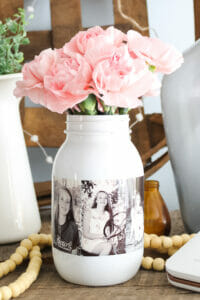 Mason jar with photos printed on adhesive paper with pink flowers